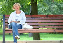 Menopause - Factors Affecting the Menopause 6 A photo showing a lady going through the menopause sitting in a park