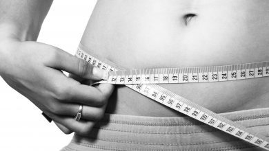 The Definition of being Fit and the 3 Methods to Measure Fitness 9 An image showing a fit woman measuring her waist