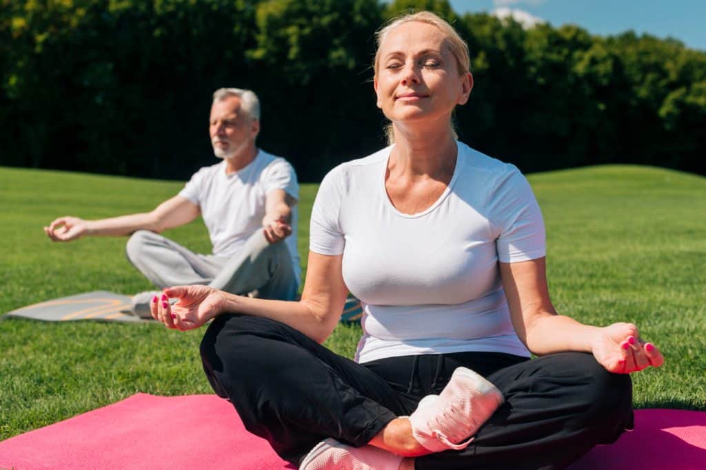 Revitalizing Your Golden Years- The Best Exercises for People Over 50 3 full shot people meditating yoga mats