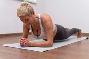 Measuring Your Fitness Level after 50- The Ultimate Guide 5 senior woman indoors doing stretching exercises