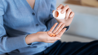 a woman holding longevity supplements